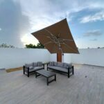 modern outdoor patio with sofa and umbrella