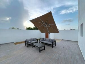 modern outdoor patio with sofa and umbrella