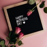 pink roses on a letterboard with message on a pink surface