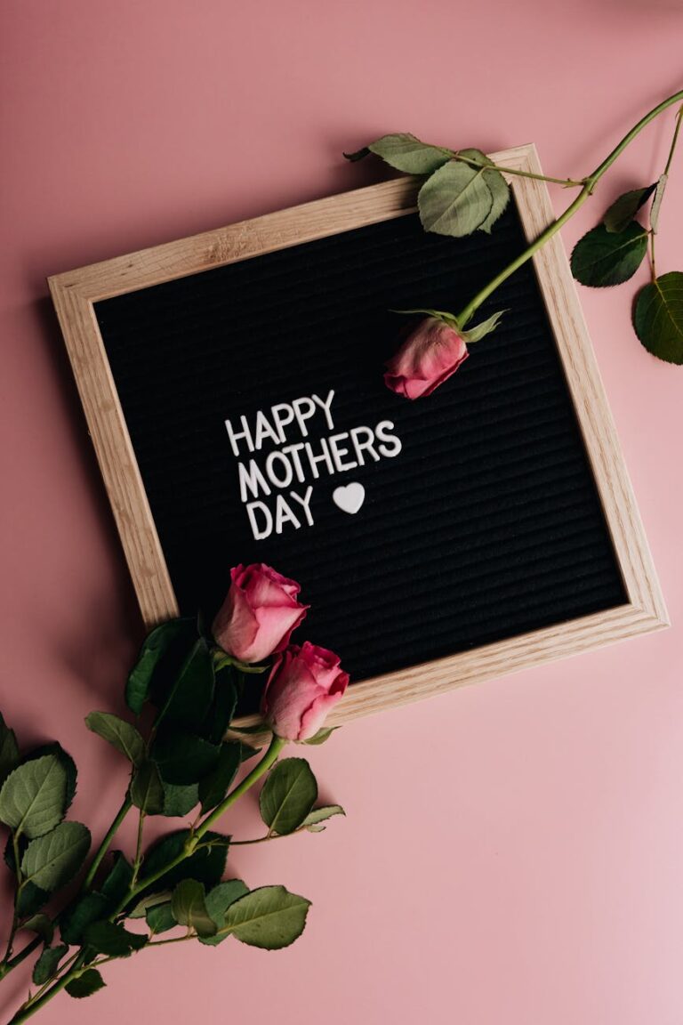 pink roses on a letterboard with message on a pink surface